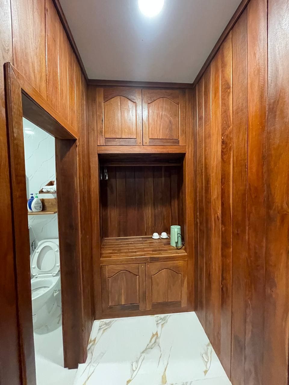 Wooden wardrobe hallway leading to bathroom